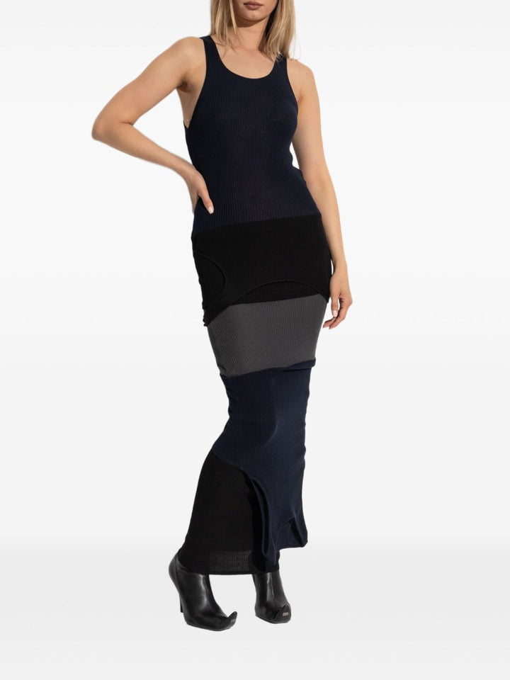 Woman wearing a black and gray dress with a white background