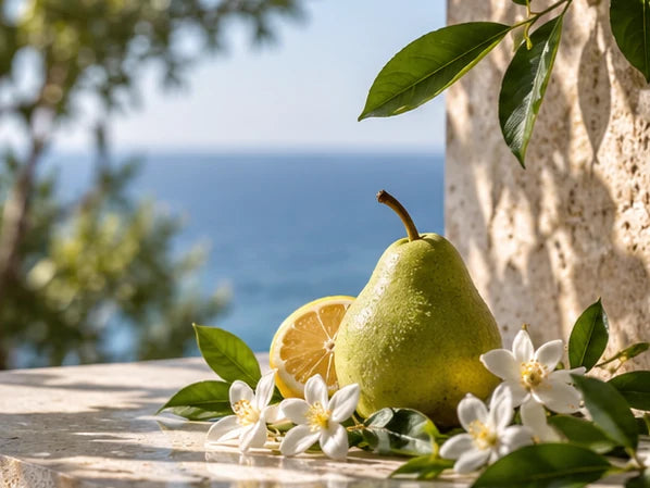 Fresh and Solar editorial: green pear, citrus and white flowers overlooking sunlit blue Mediterranean sea
