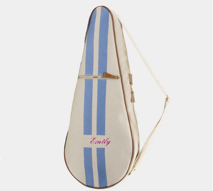 A personalized guitar case in cream canvas with two vertical blue stripes, a pink embroidered name &